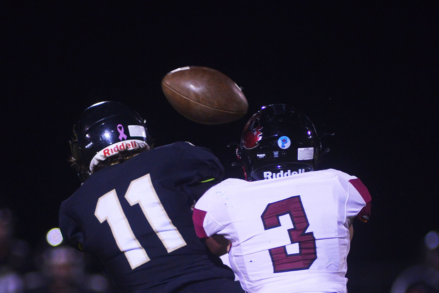 Anthony Peters searches for the pass as defensive back Ki Girgen looks for an interception